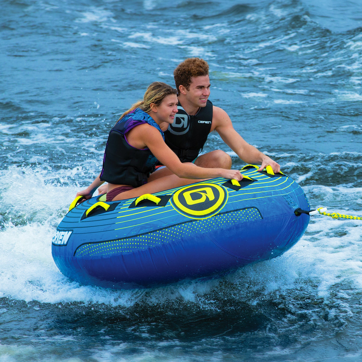 Two riders, in life vests, enjoy tubing on an OBrien Super LeTube Towable Tube.