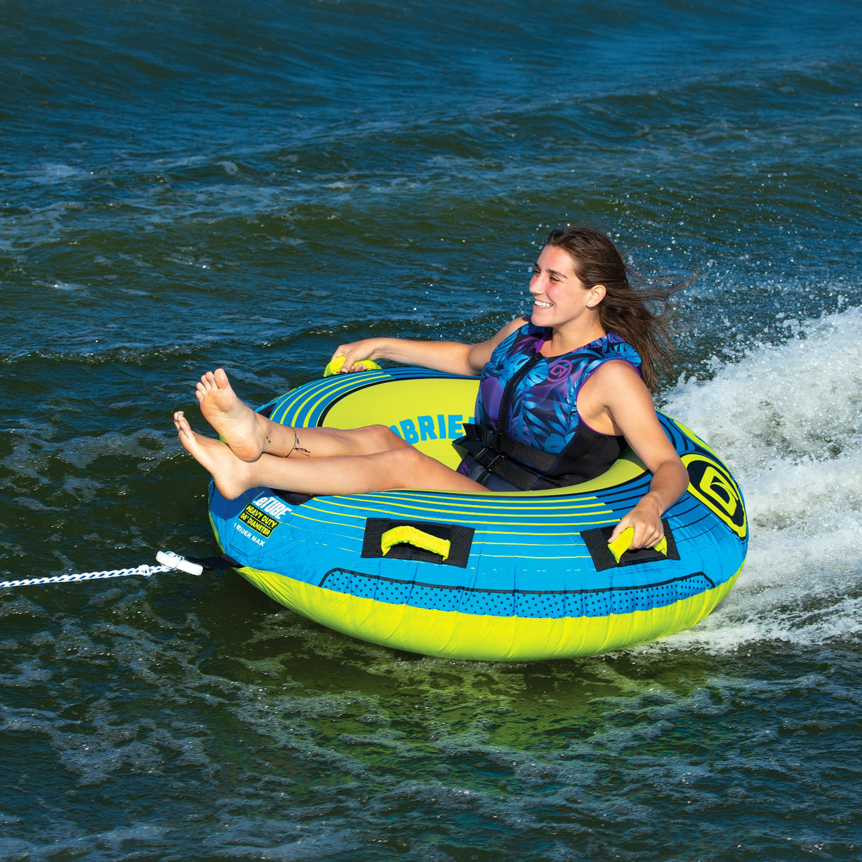 Smiling person on OBrien LeTube Towable Tube, wearing a life vest, single rider.