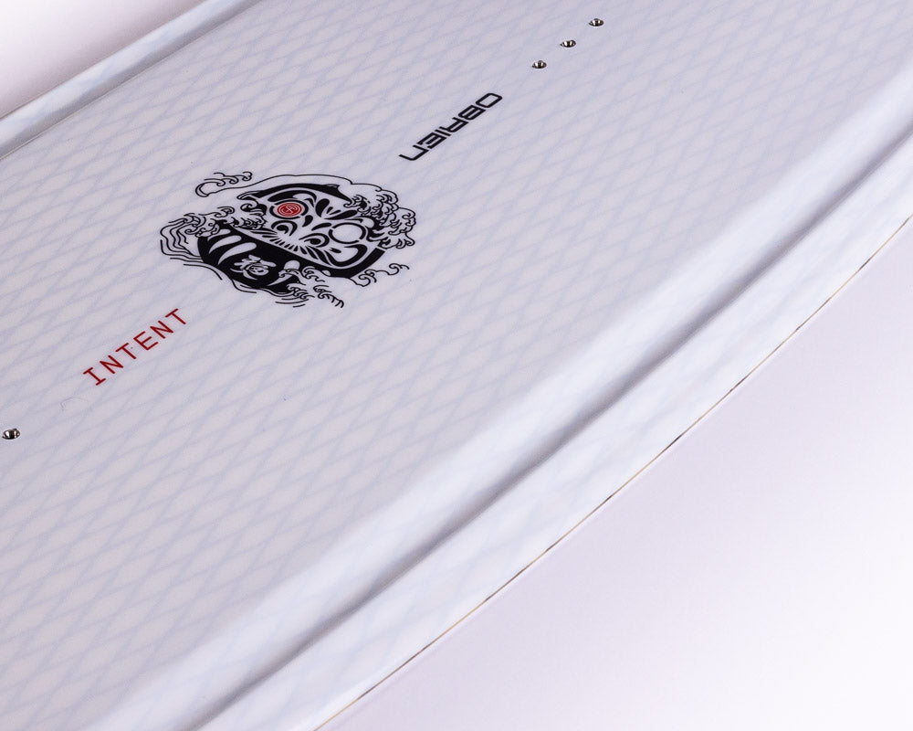 Close-up of O'Brien Intent Wakeboard’s textured white deck featuring a black tribal-style logo and "INTENT" text.
