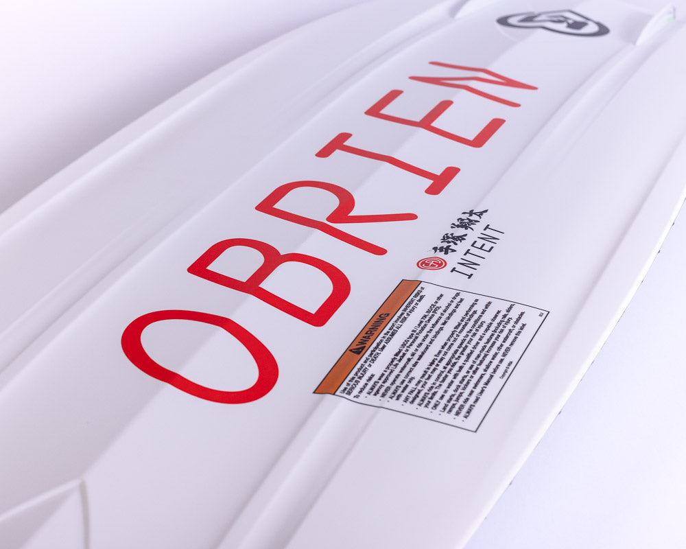 O'Brien Intent Wakeboard base close-up in white with red branding, a warning label, and bold channeling.