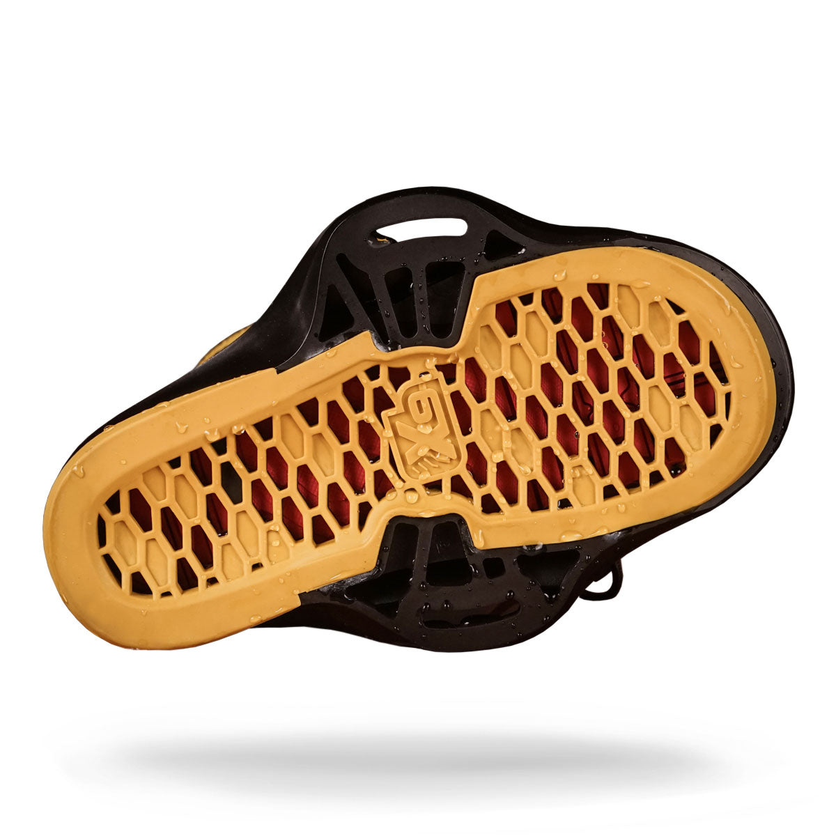 The Liquid Force wakeboard boot sole showcases a vibrant honeycomb pattern in red and yellow.