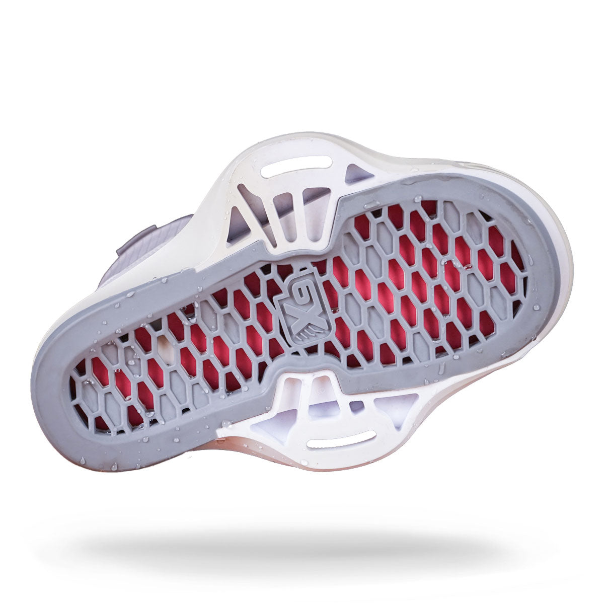 Bottom view of a wakeboard binding with white/pink hexagonal sole with glossy accents, showcasing mounting construction.