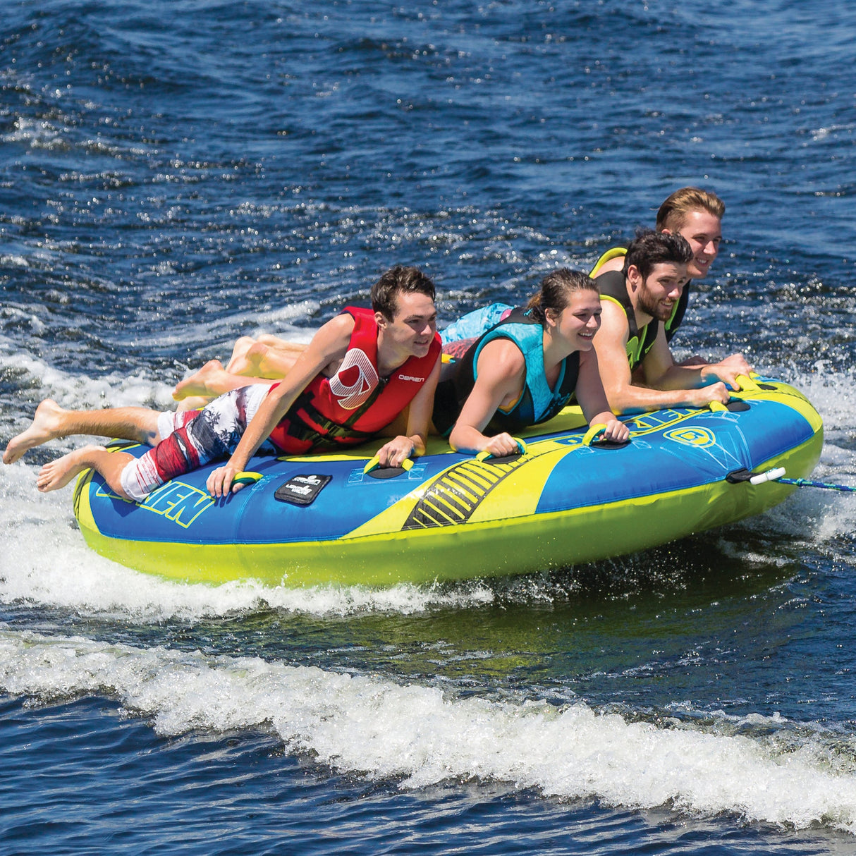Four friends enjoy the OBrien X-Scream Boat Tube, all in life vests.