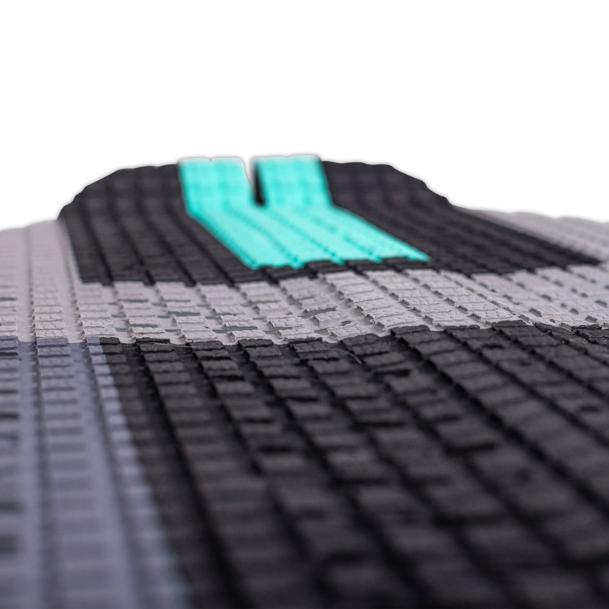 Closeup of the gray, black, and teal textured footpad of the Havana wakesurf board.