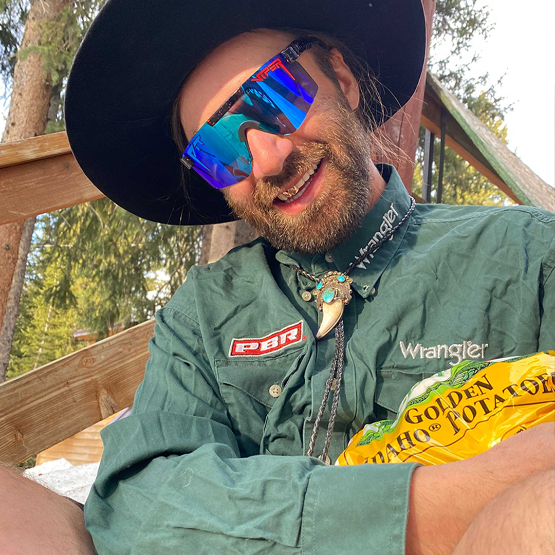 Narrow / Polarized Blue | Yellowlight.JPG | Man hugging a bag of potatoes wearing The Peacekeeper Original from Pit Viper Sunglasses