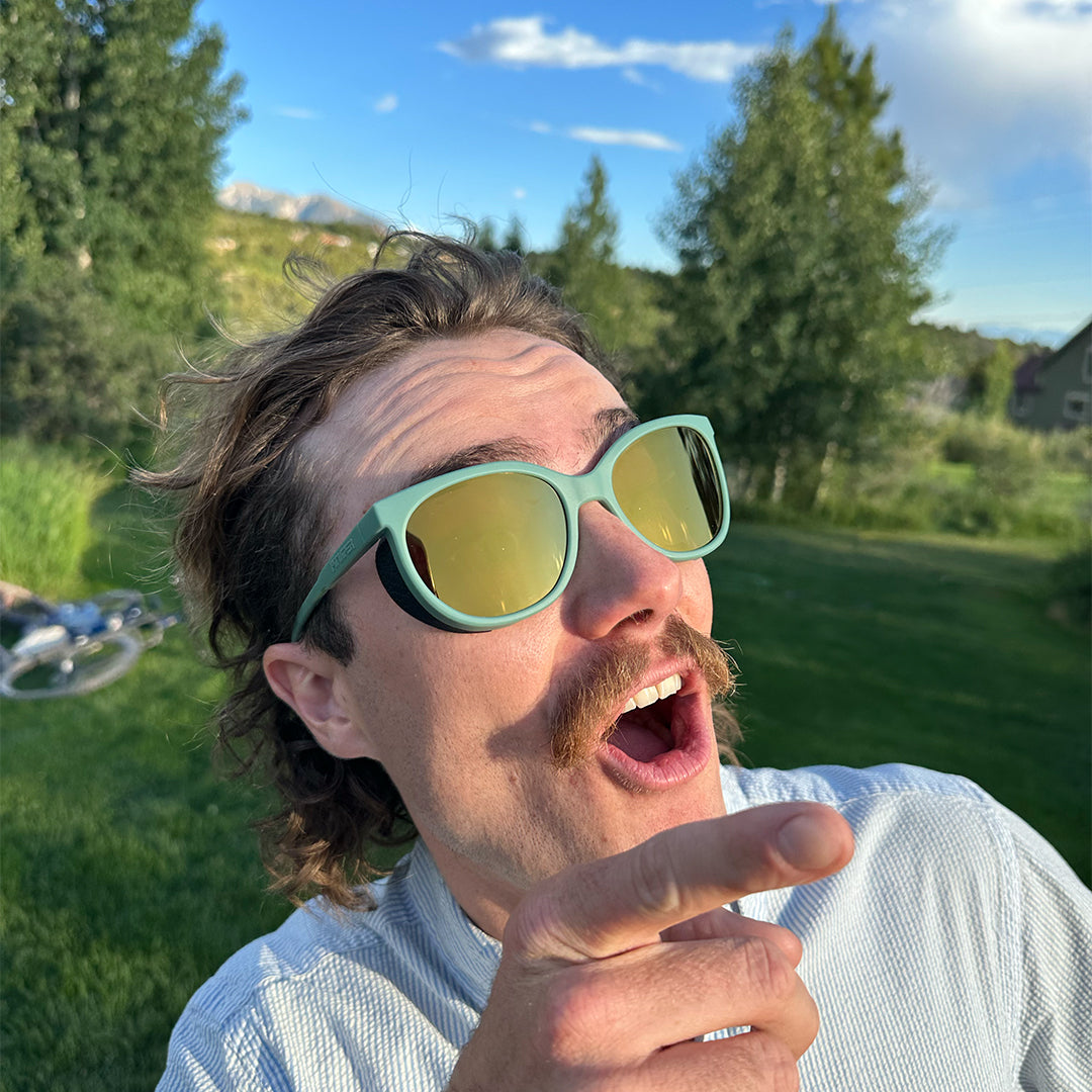 / Gold | ice_cream.JPG | Man pointing at the sky wearing Pit Viper Sunglasses