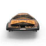 Black and orange surfboard with textured grip pads, viewed from the back.