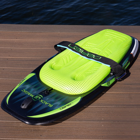 Angled top view of O'Brien Black Magic Kneeboard showing green pad, strap, and deck design.