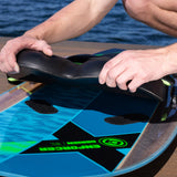 Hands lifting the removable black knee pad from the O'Brien Enforcer Kneeboard deck.
