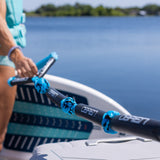 Girl holding a surf rope while holding a surf board