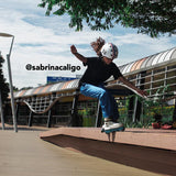 Girl doing rollerskate tricks while wearing a white Melon "Beetle" Bicycle Helmet