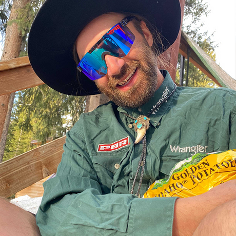 Narrow / Polarized Blue | Yellowlight.JPG | Man hugging a bag of potatoes wearing The Peacekeeper Original from Pit Viper Sunglasses