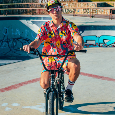 Wide / Polarized Pink | walked_in_on_me.JPG | Man on a BMX bike wearing The Gobby Original from Pit Viper Sunglasses