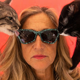 Smoke | chicken_thigh.JPG | Women wears The Marissa’s Nails Clawdia with a smoke lens from Pit Viper. Cat licks the lens