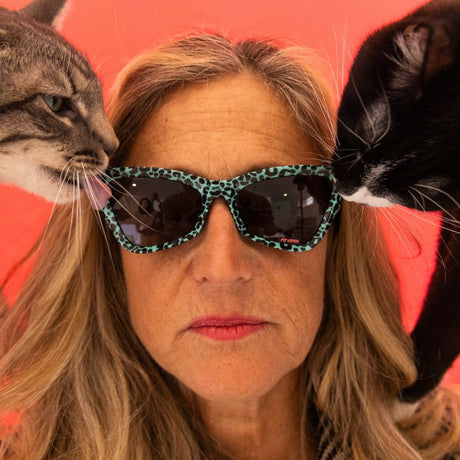 Smoke | chicken_thigh.JPG | Women wears The Marissa’s Nails Clawdia with a smoke lens from Pit Viper. Cat licks the lens